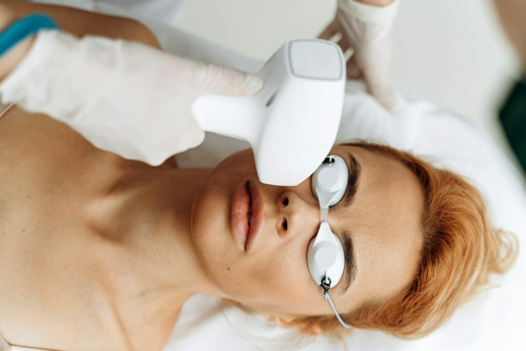 Close up of female face having laser rejuvenating treatment.